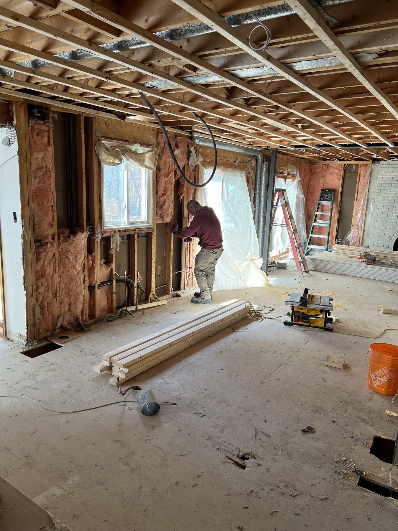 Exterior wall stripped to the studs during renovation, with insulation exposed