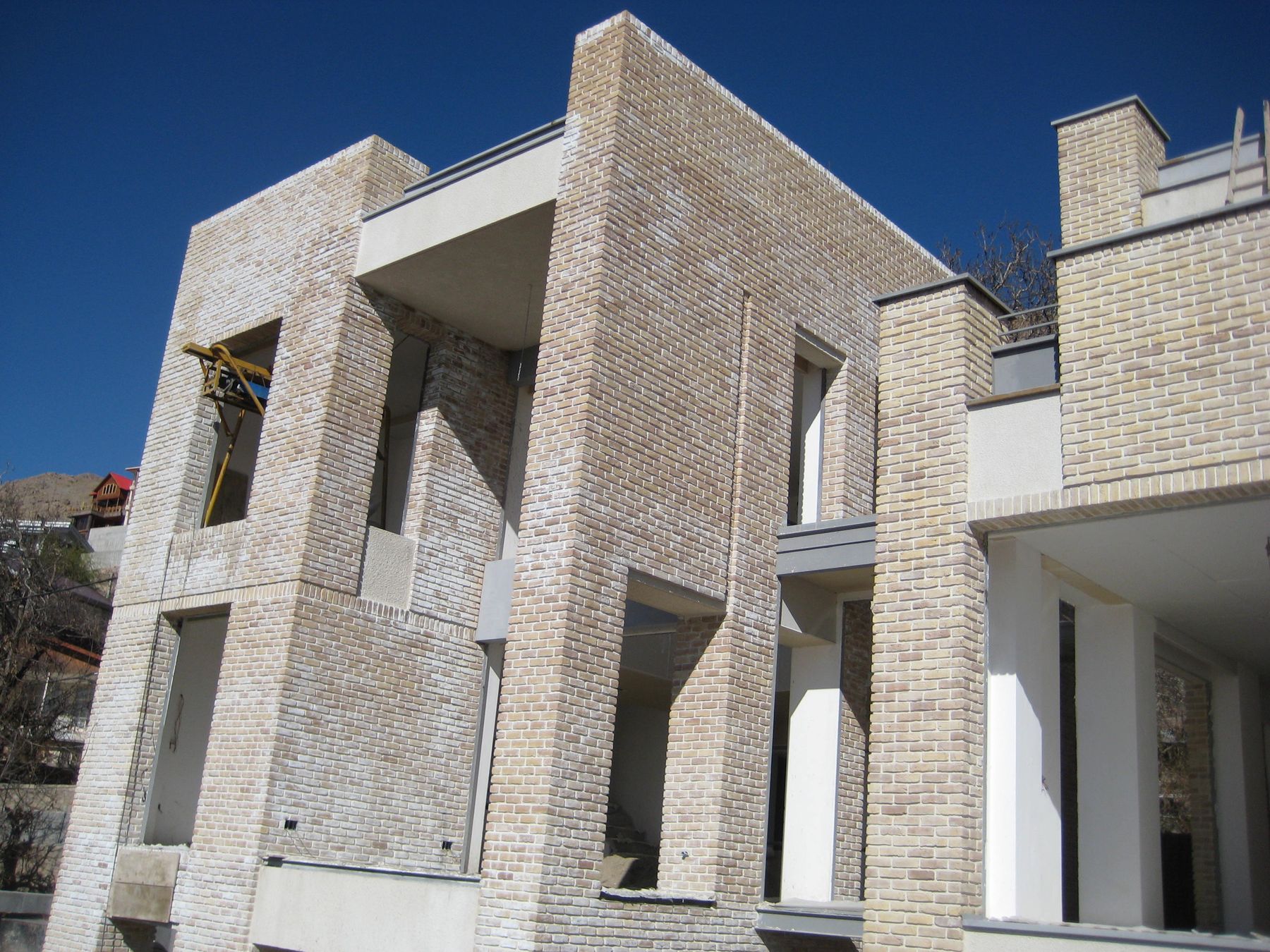 New brick walls and window openings of a house under construction
